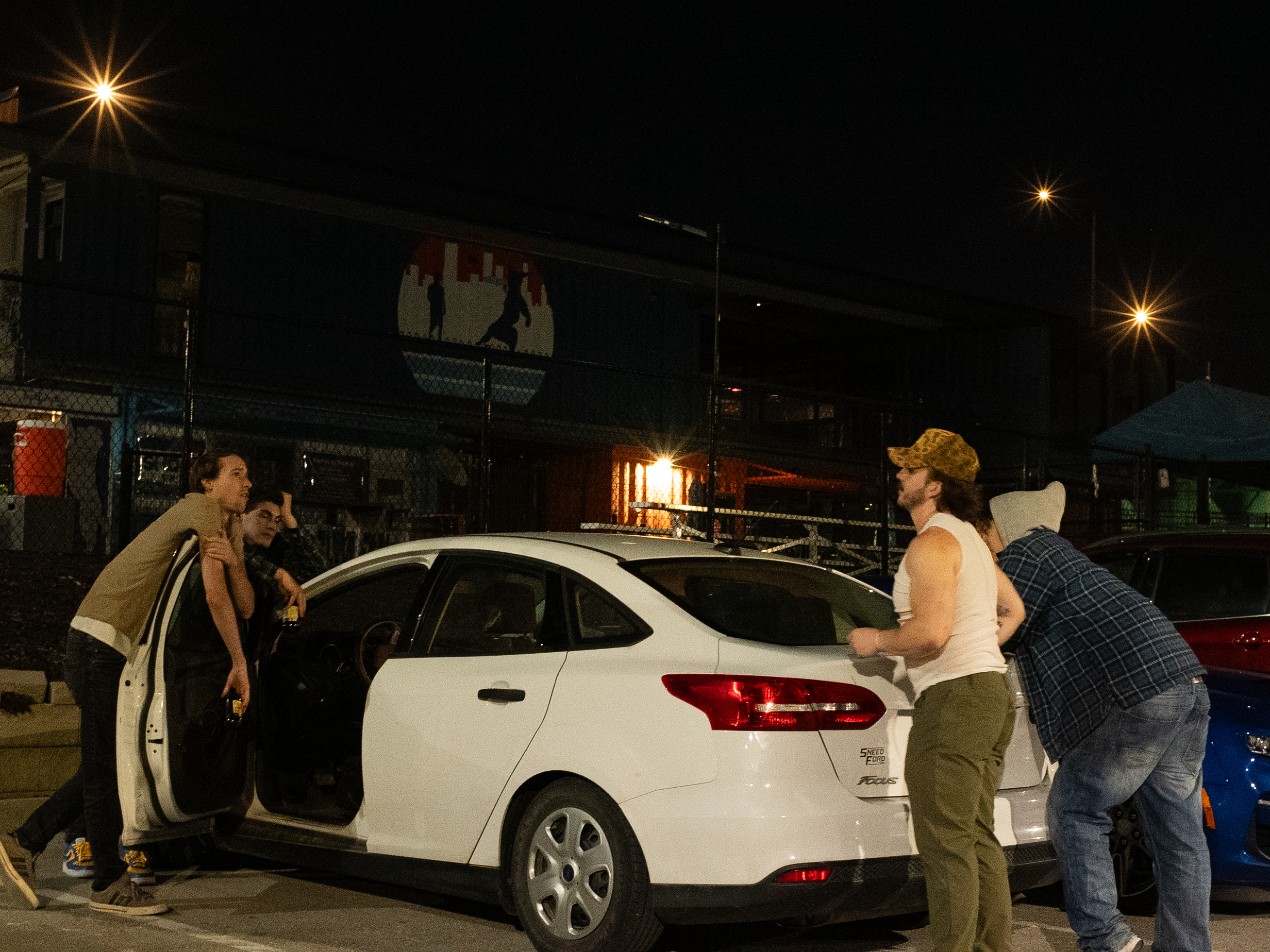 Characters gathered near a car in The Thrill of Speed